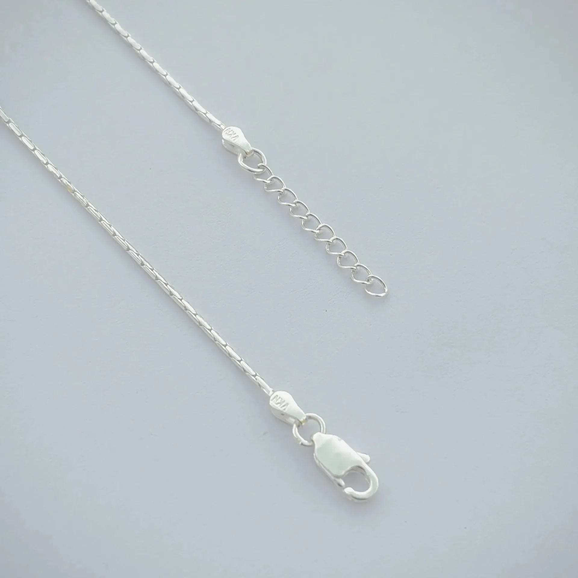 Sleek Silver Anklet with Oval-Shaped Silver Beads.