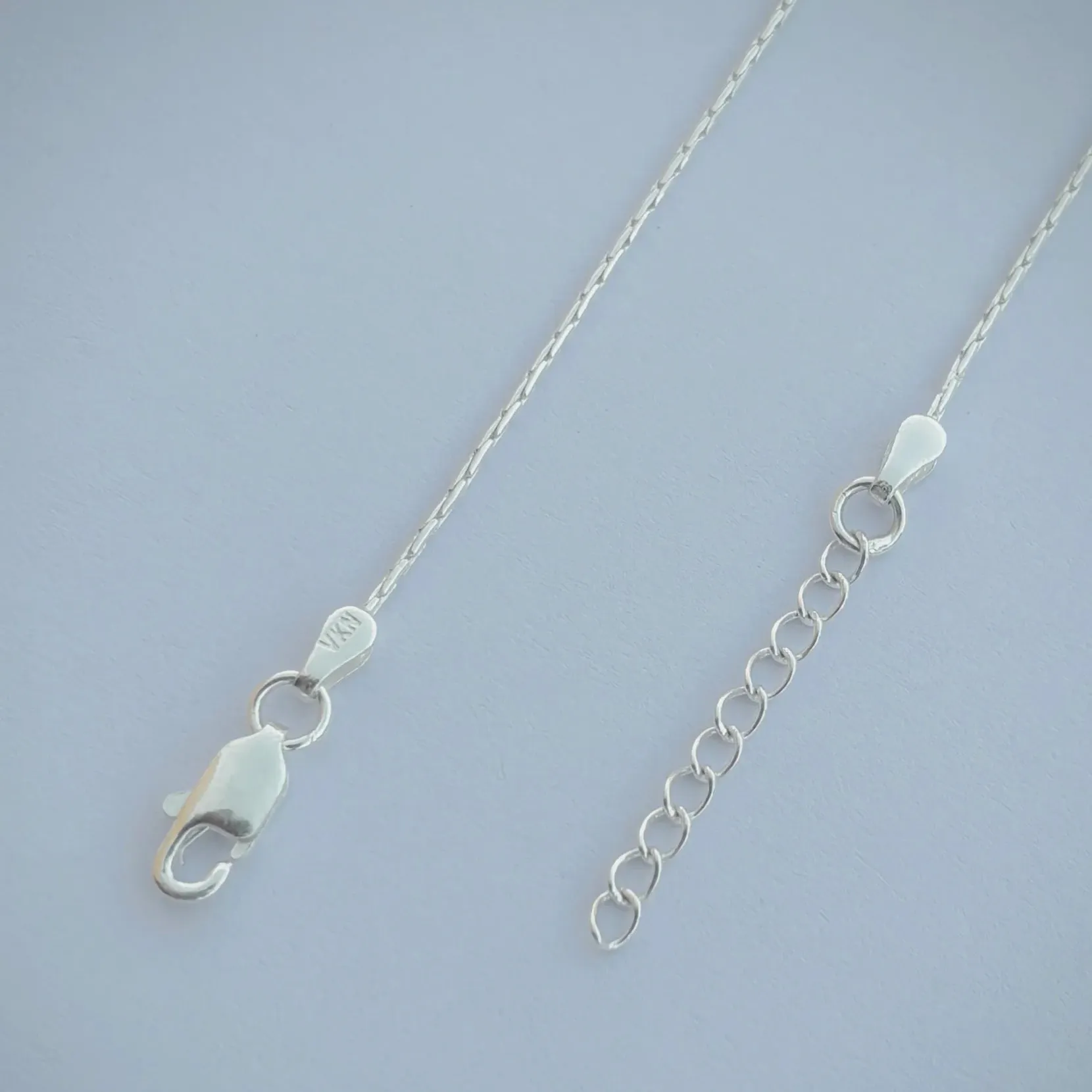 Sleek Silver Anklet with Oval-Shaped Silver Beads.